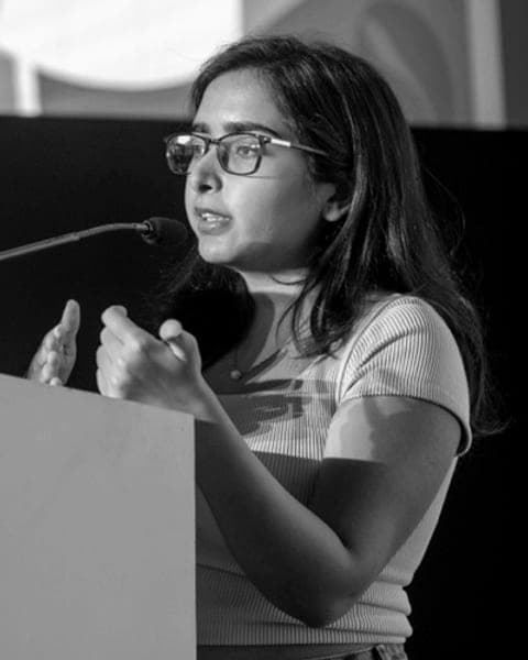 Reet speaking on stage at ETH India